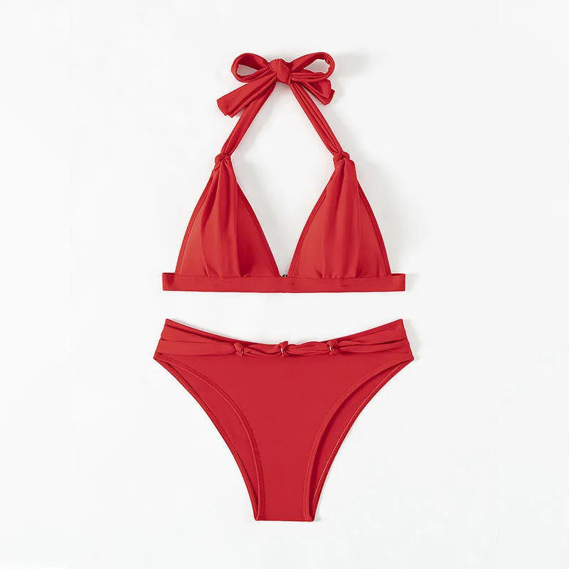 Red women's halterneck lace-up bikini with split shorts for swimming
