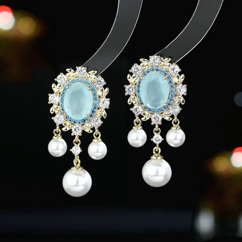 Oval zircon inlaid pearl tassel earrings with geometric design and decorative hanging elements