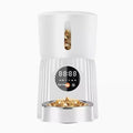 Black intelligent pet feeder with digital display showing feeding schedule