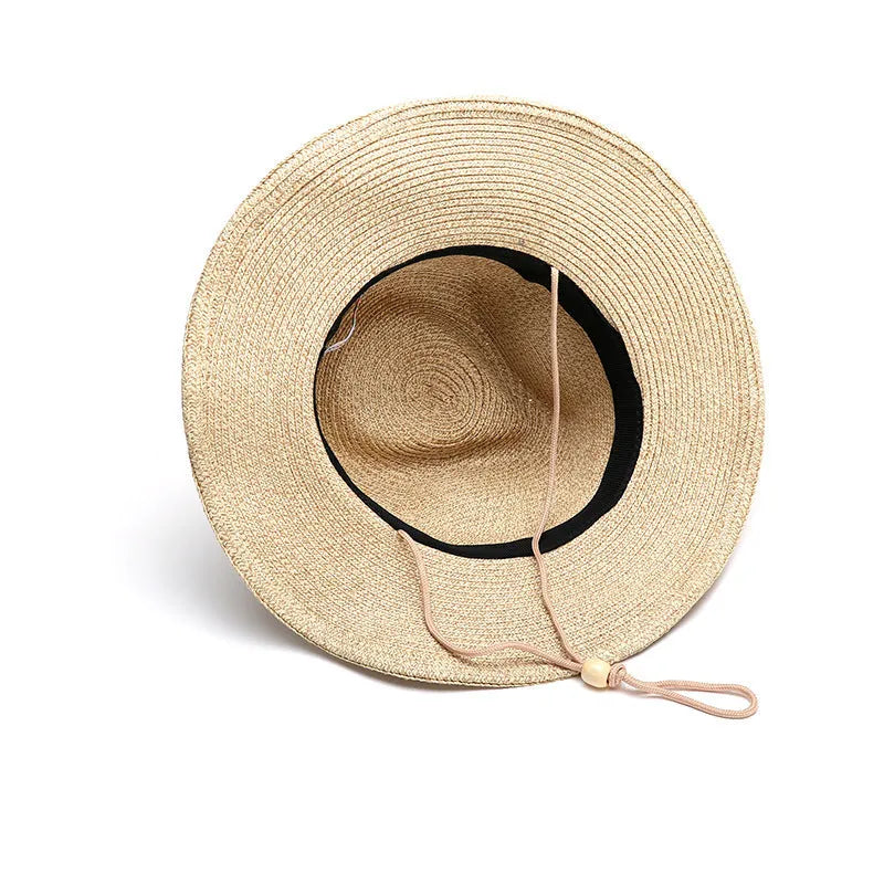 Men's foldable straw sun hat with big brim in beige colour on outdoor background