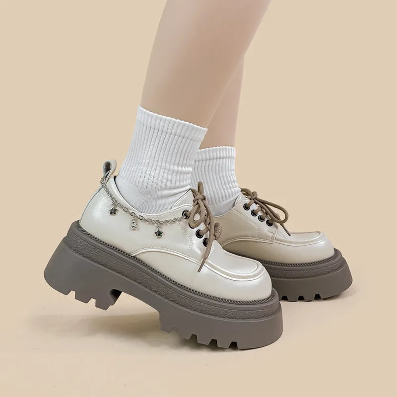 White platform Mary Jane shoes with chunky heel and front lace-up, featuring XINGX bear design.