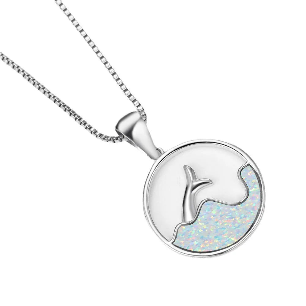 Gold tone geometric fishtail pendant necklace with a round blue opal centre on a chain.