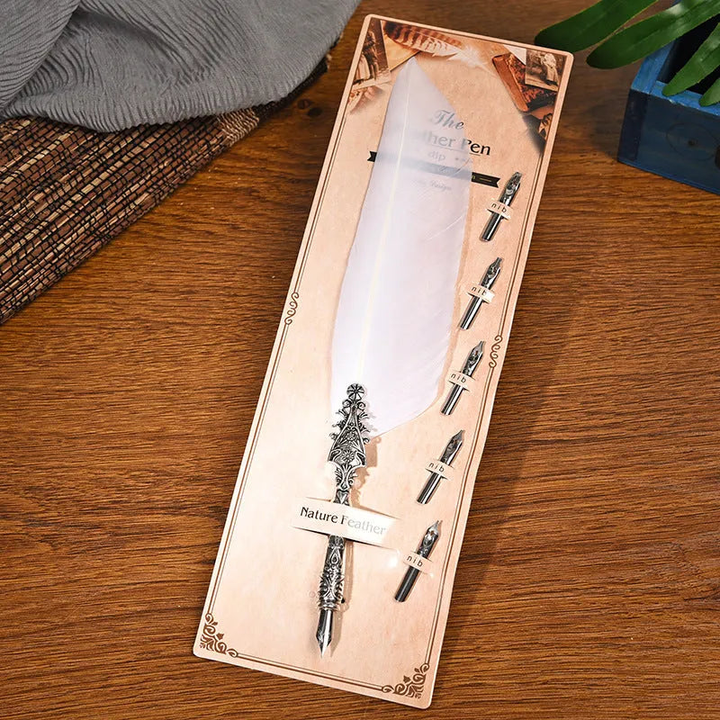 Vintage feather dip pen with zinc alloy shell in various colour options on a desk.