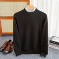Men's half-turtleneck loose fit wool sweater in a neutral colour on a hanger.