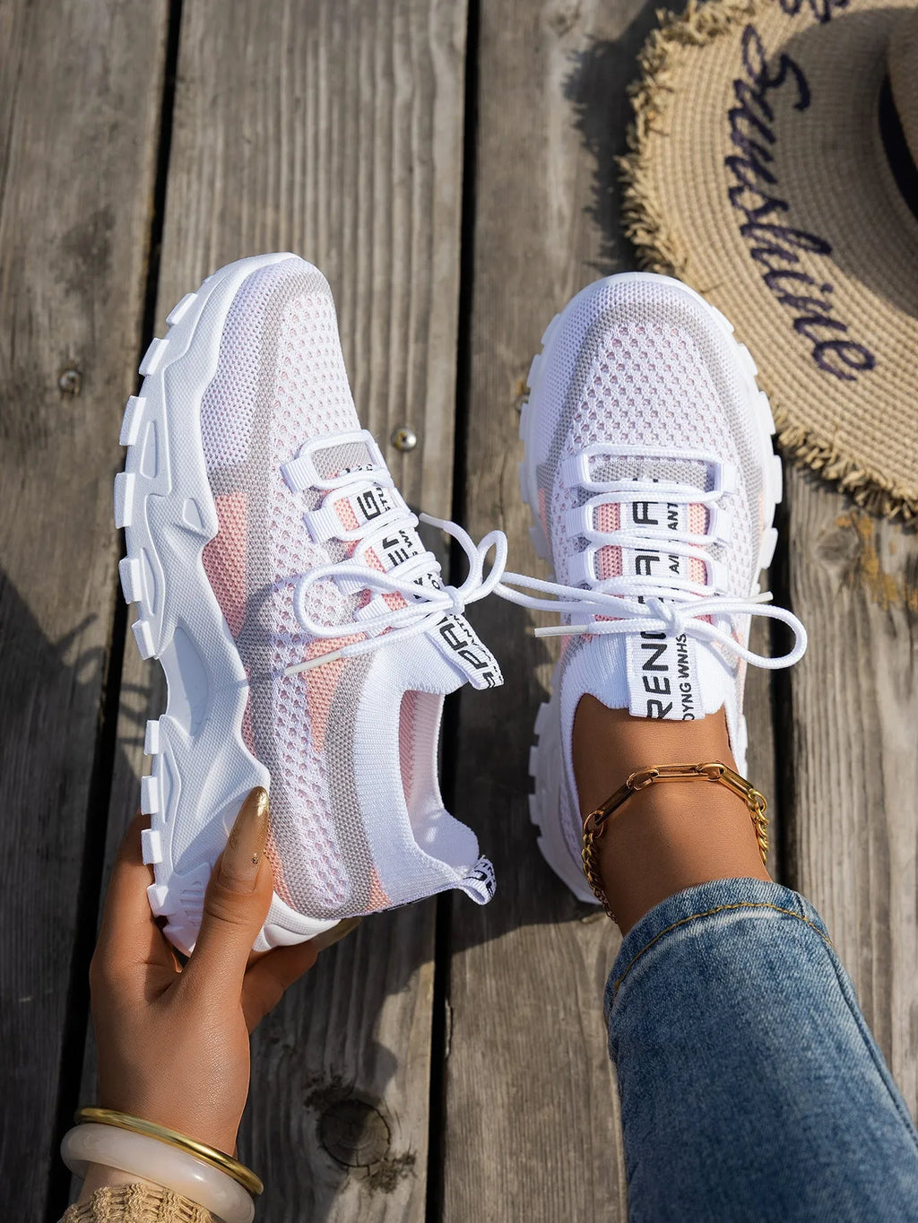 Women's Flyknit mesh lace-up sneakers in a grey colourway, showing the breathable upper and rubber sole.