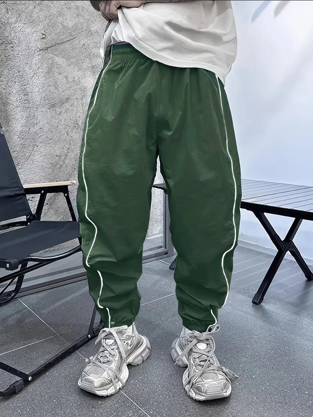 Man wearing loose-fit, cropped-length casual trousers in bamboo fibre, shown in khaki colour
