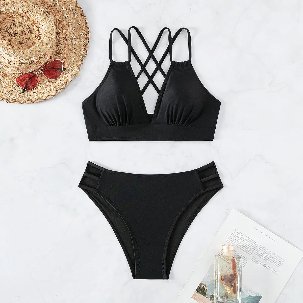 Adult women's black V-neck halter bikini with split-leg high-cut shorts.