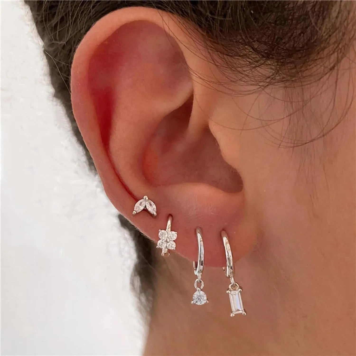 Copper geometric square earrings with electroplated gold or silver finish showing star and quadrilateral design elements