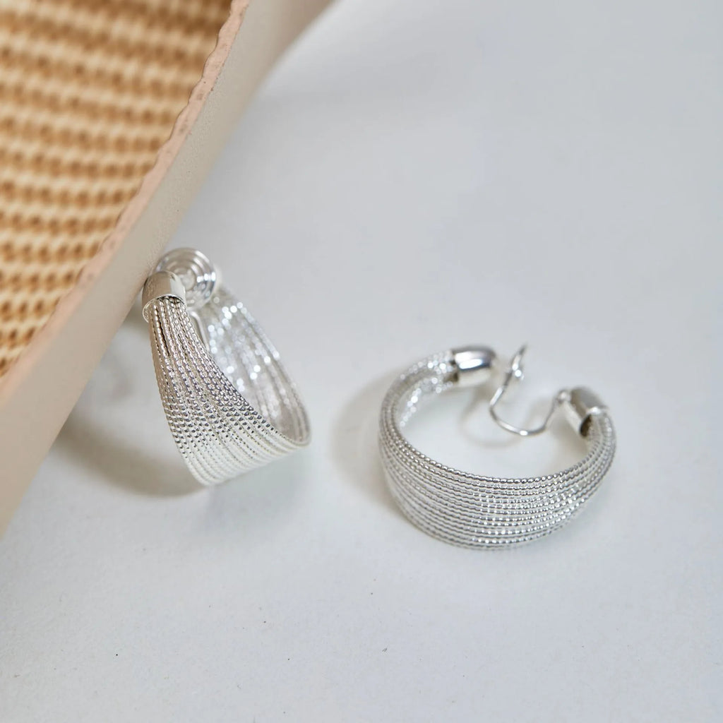 Multi-layer geometric earrings in gold and silver with stud and clip style options