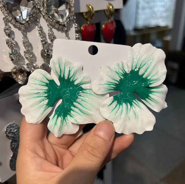 A pair of pastoral style flower stud earrings with an oil-spot glaze finish in an alloy setting.