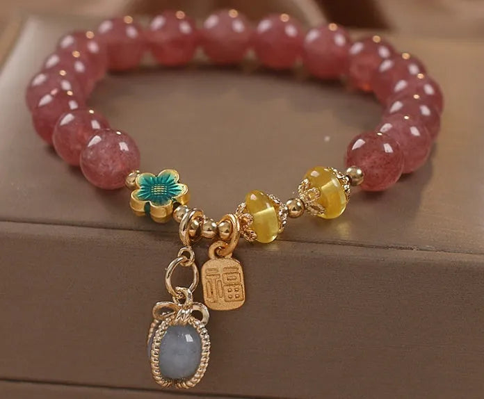 Red women's beaded bracelet with natural strawberry quartz stones, alloy metal, and rhinestone details.