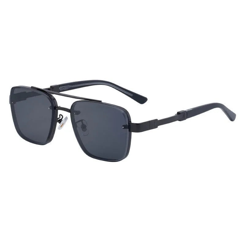 Men's vintage sunglasses with gold frame and grey lenses on a plain background.
