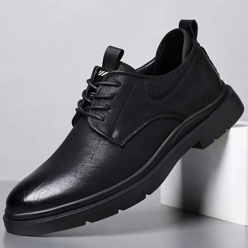 Men's black and brown leather casual sneakers with decorative stitching and a rubber sole.