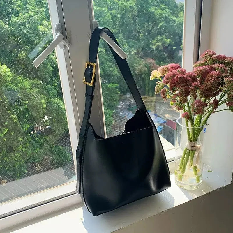 Women's soft PU leather shoulder bag with swing threads design in black or brown, showing 28x32x12cm dimensions