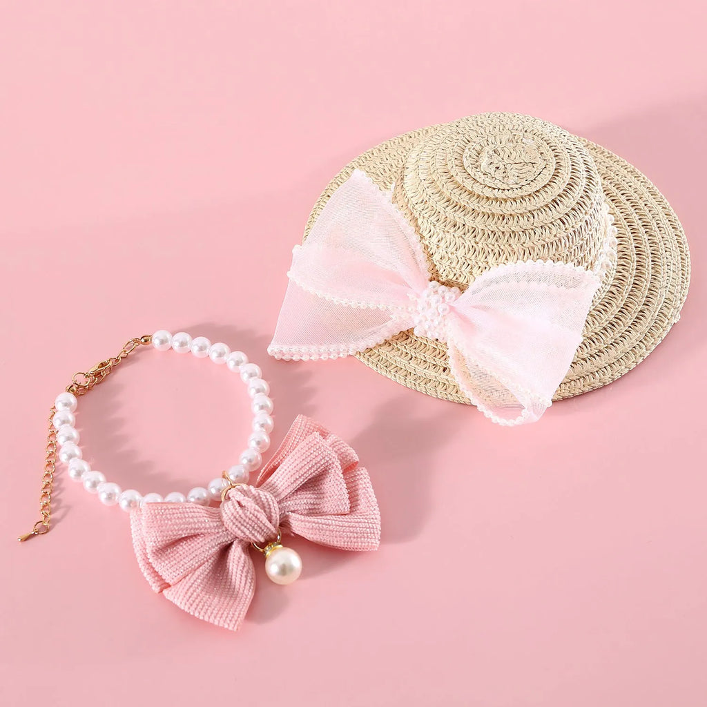 Pink pearl butterfly bow woven straw hat for a cat on a mannequin head.