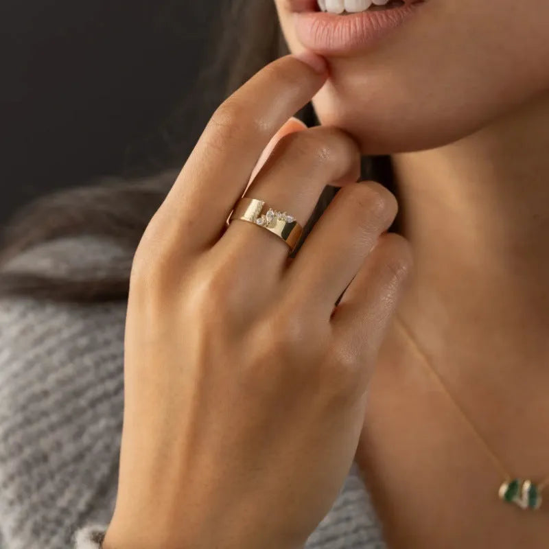 Gold-coloured women's ring with zircon accents on copper base, showing electroplated finish and personality style design.