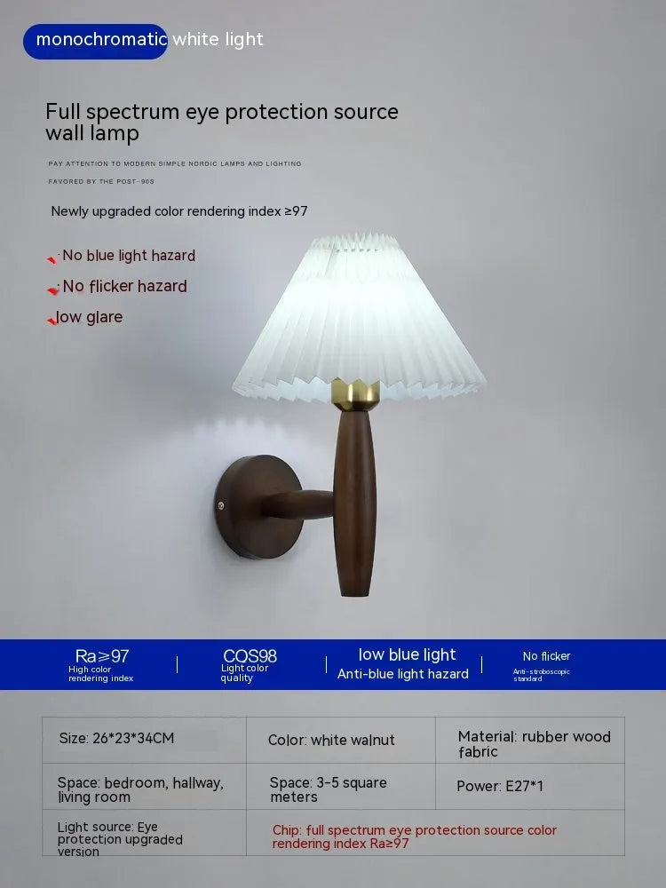 American retro rubber wood and fabric wall lamp in walnut finish on a wall.