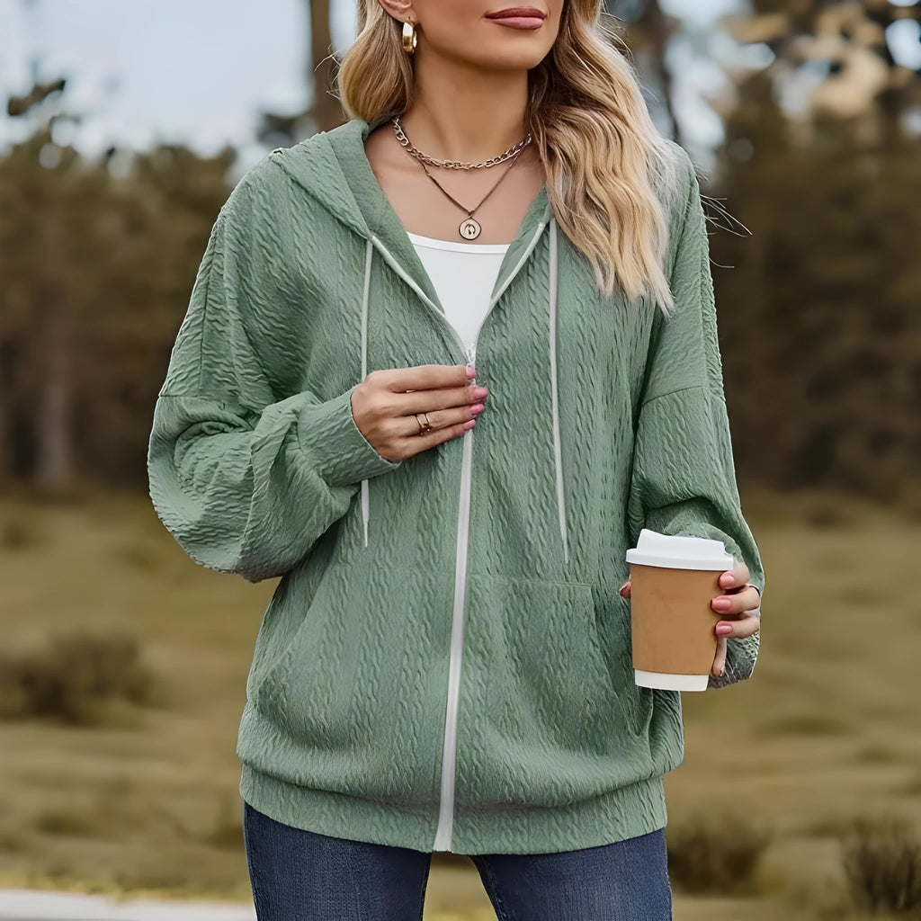 Green women's hooded zipper coat with a loose fit and long sleeves.