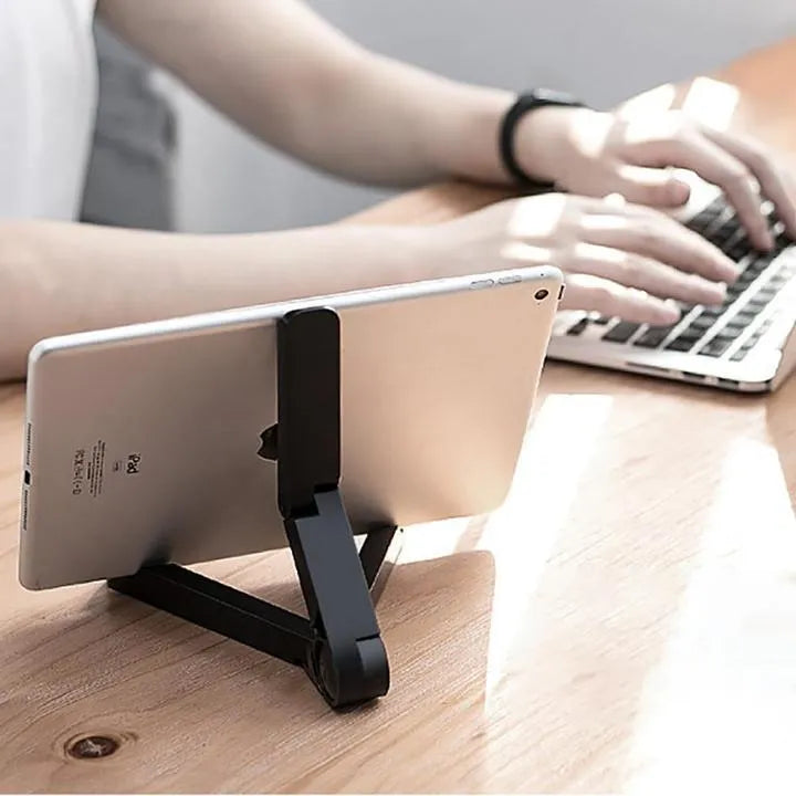 Black foldable tablet holder showing adjustable angle stand with phone positioned in landscape orientation