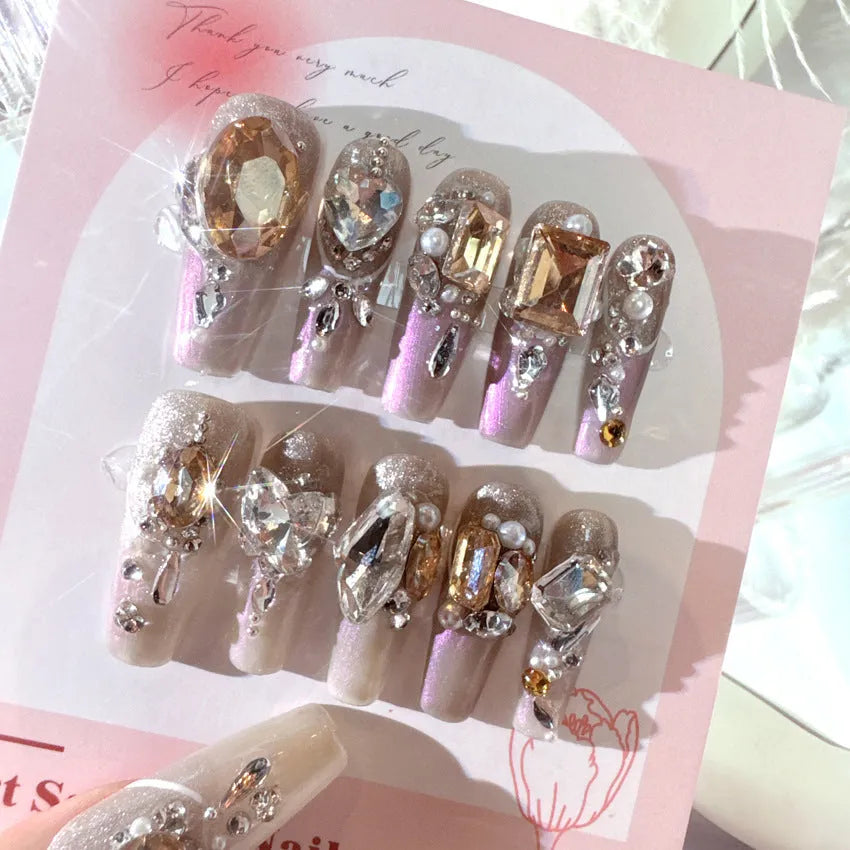 Rhinestone decorated false nail patches on a card, with jelly adhesive or tool set options.
