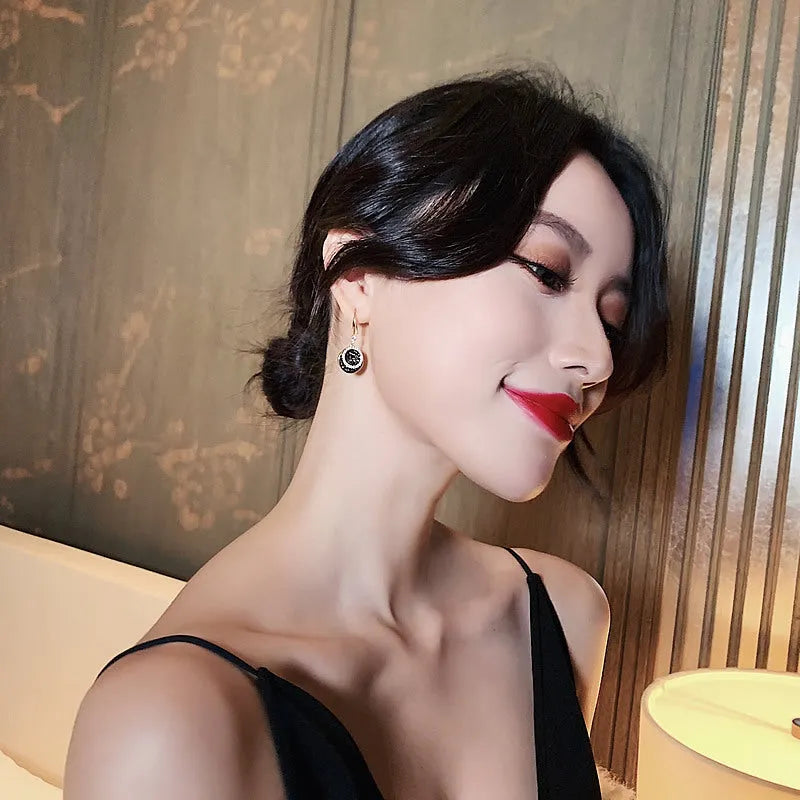 Black retro Hong Kong style alloy earrings with circular geometric design measuring 3.6cm length