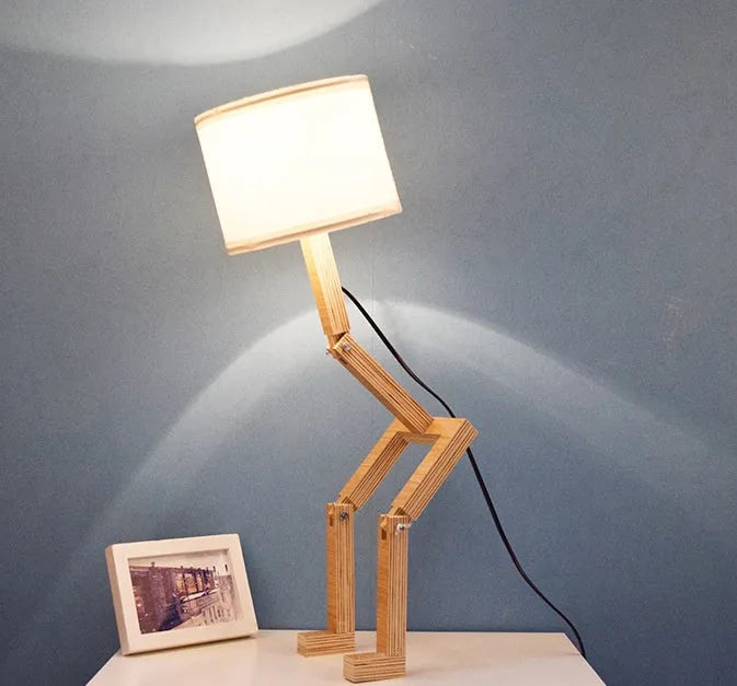 Creative small humanoid wooden table lamp with white fabric shade, 22x44x16cm, on bedside table
