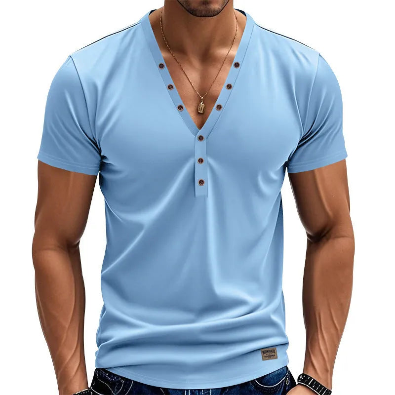 Man wearing a loose fit solid colour V-neck pullover top with a small button design detail.