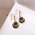Black retro Hong Kong style alloy earrings with circular geometric design measuring 3.6cm length