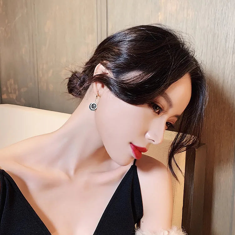 Black retro Hong Kong style alloy earrings with circular geometric design measuring 3.6cm length