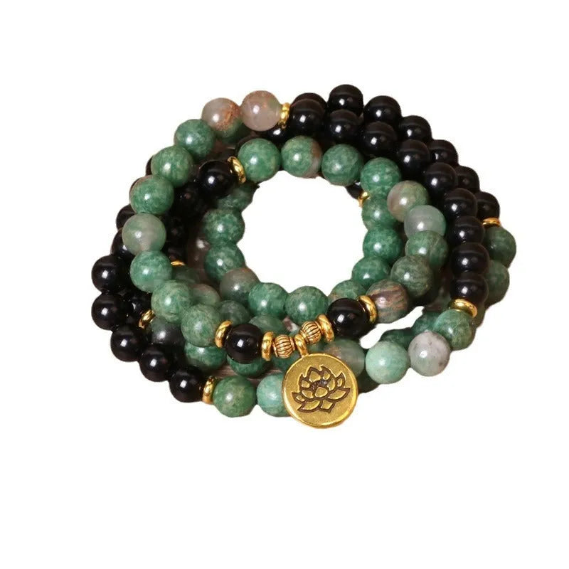 Green and black alloy beads on a stretch elastic bracelet band.