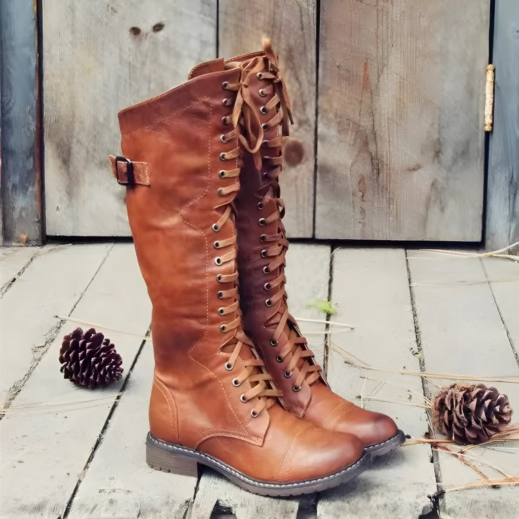 Women's black high leg boots with a chunky low heel and round toe on a plain background.