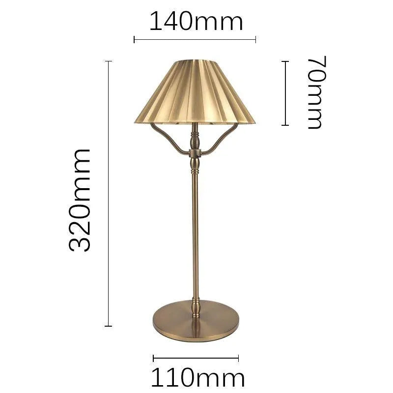 Gold alloy desk lamp with touch control on a wooden desk.