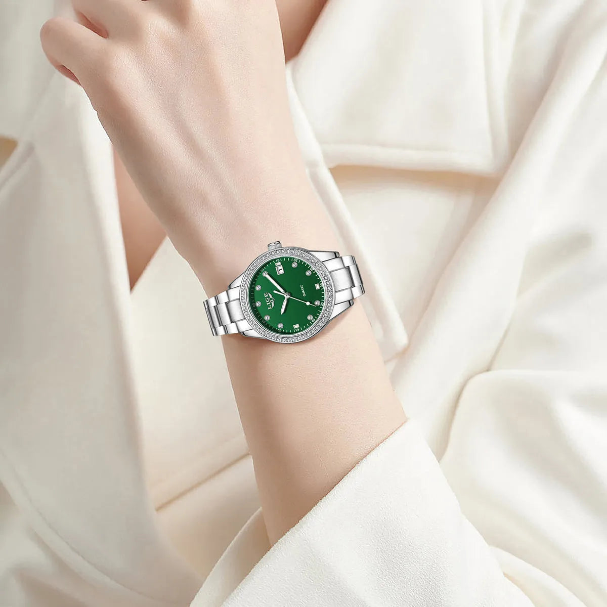 Women's silver quartz watch with diamond hour markers and luminous hands on 34mm round dial