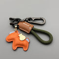 Handmade cowhide car keychain pendant with a zinc alloy pony buckle and coloured flanelle rope strap.