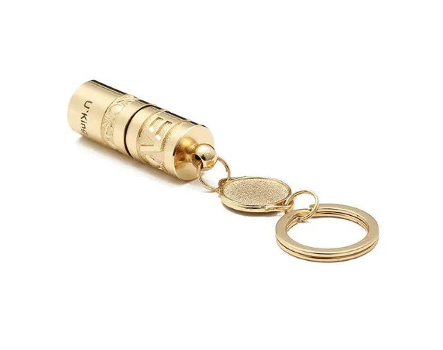 Gold zinc alloy LED flashlight attached to a keyring for outdoor and emergency use.