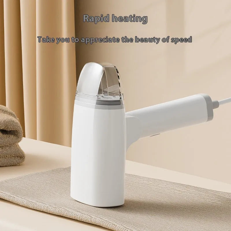 Blue handheld garment steamer with mechanical controls and water tank