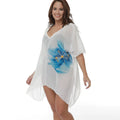 White loose-fit plus size beach cover-up blouse on a hanger.