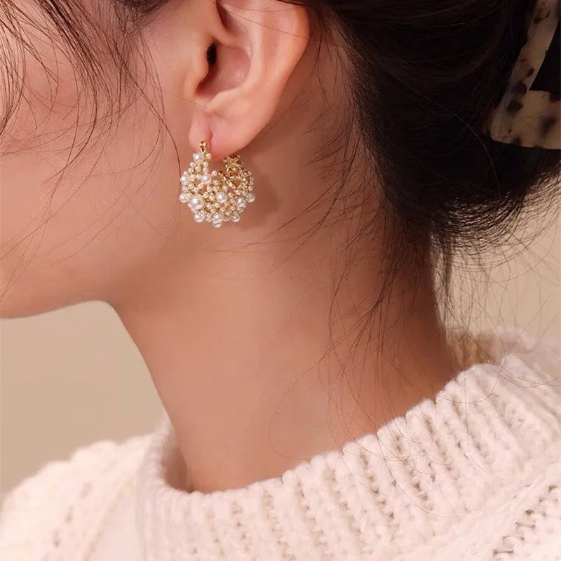 Gold-coloured copper basket flower earrings with pearl inlay and small rice-shaped bead detailing