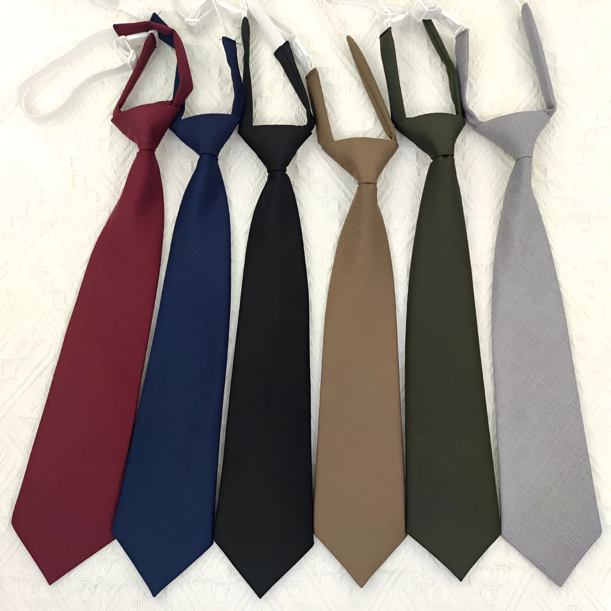 Solid colour cotton bow tie in arrow style showing navy blue option