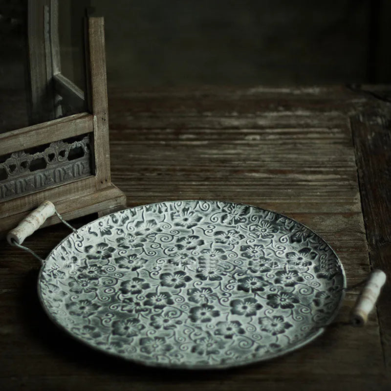 Round wrought iron storage tray in two sizes on a wooden surface
