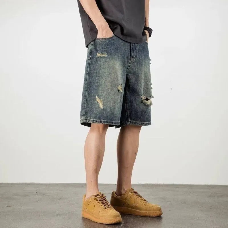 Men's blue retro loose hole denim shorts with a straight leg cut on a neutral background.