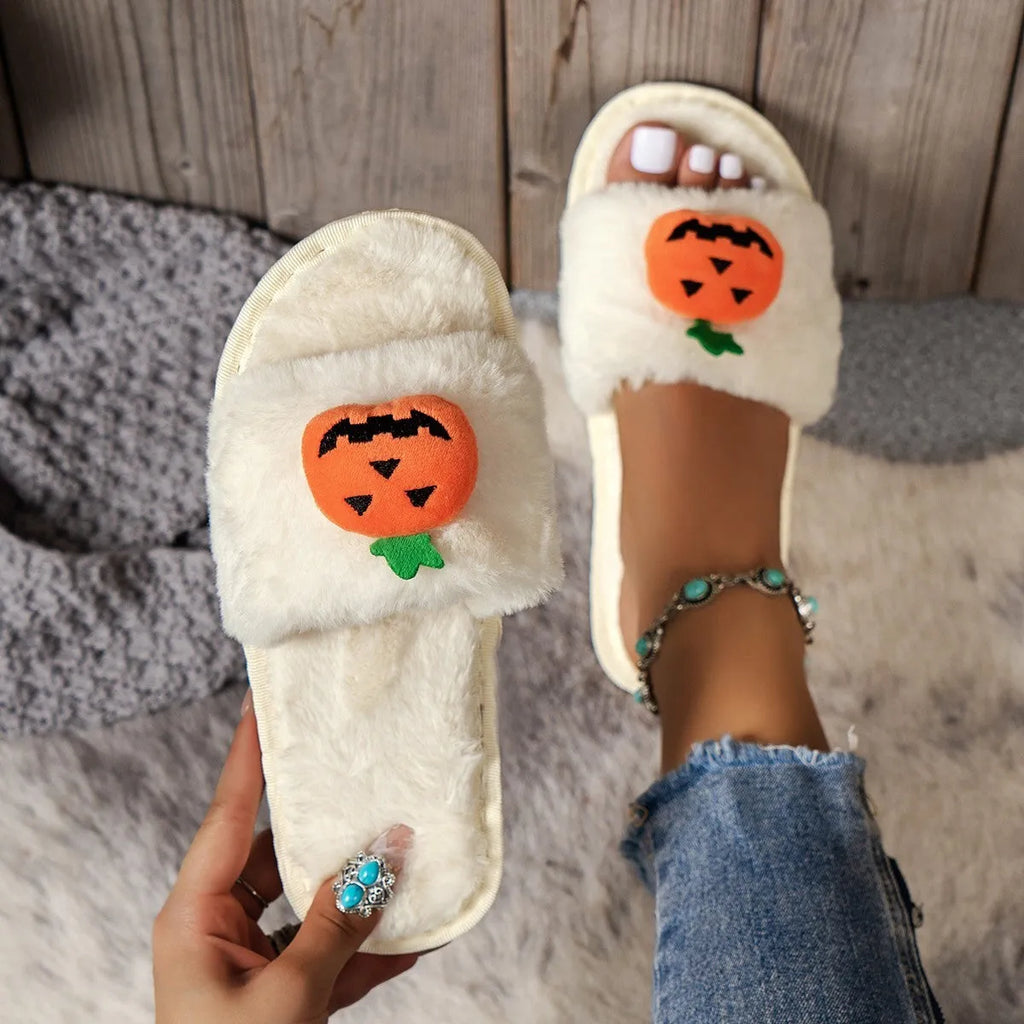 Yellow and white Halloween pumpkin cartoon design plush slippers with an open toe and textured sole.