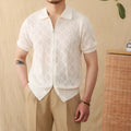 White cotton zip-front cardigan with lapel collar and short sleeves laid flat.
