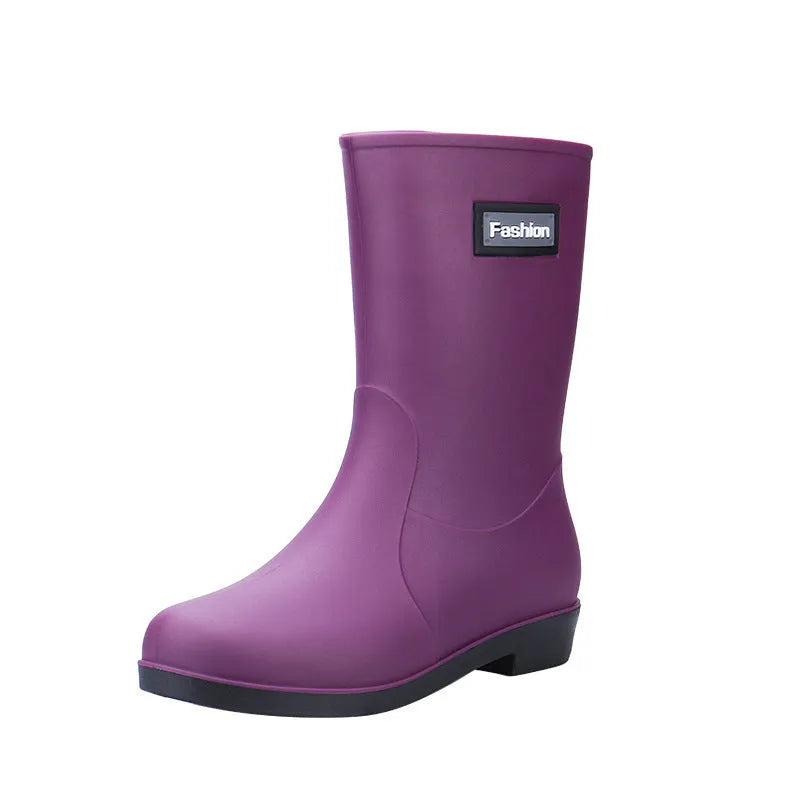 Women's mid-calf rain boots in black, PVC upper, shown with a low heel.