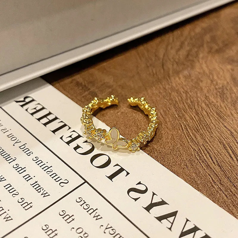 A minimalist open-loop copper ring featuring a butterfly design for women.