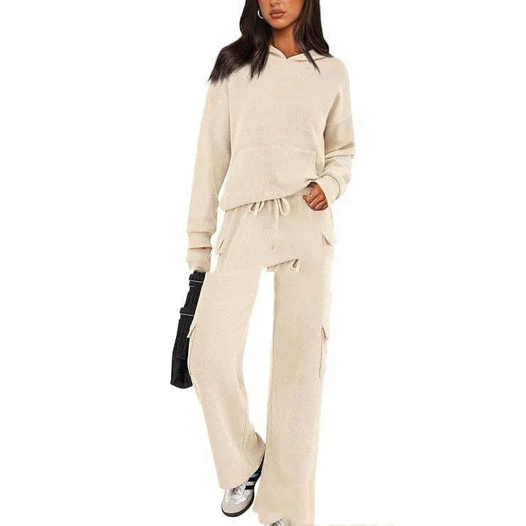 Women's black polyester sports suit with long sleeves and full-length trousers shown on a hanger.