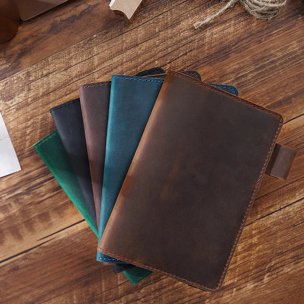 Handmade vintage Kraft notebook with cowhide cover in dark green, open to show wood-free paper pages