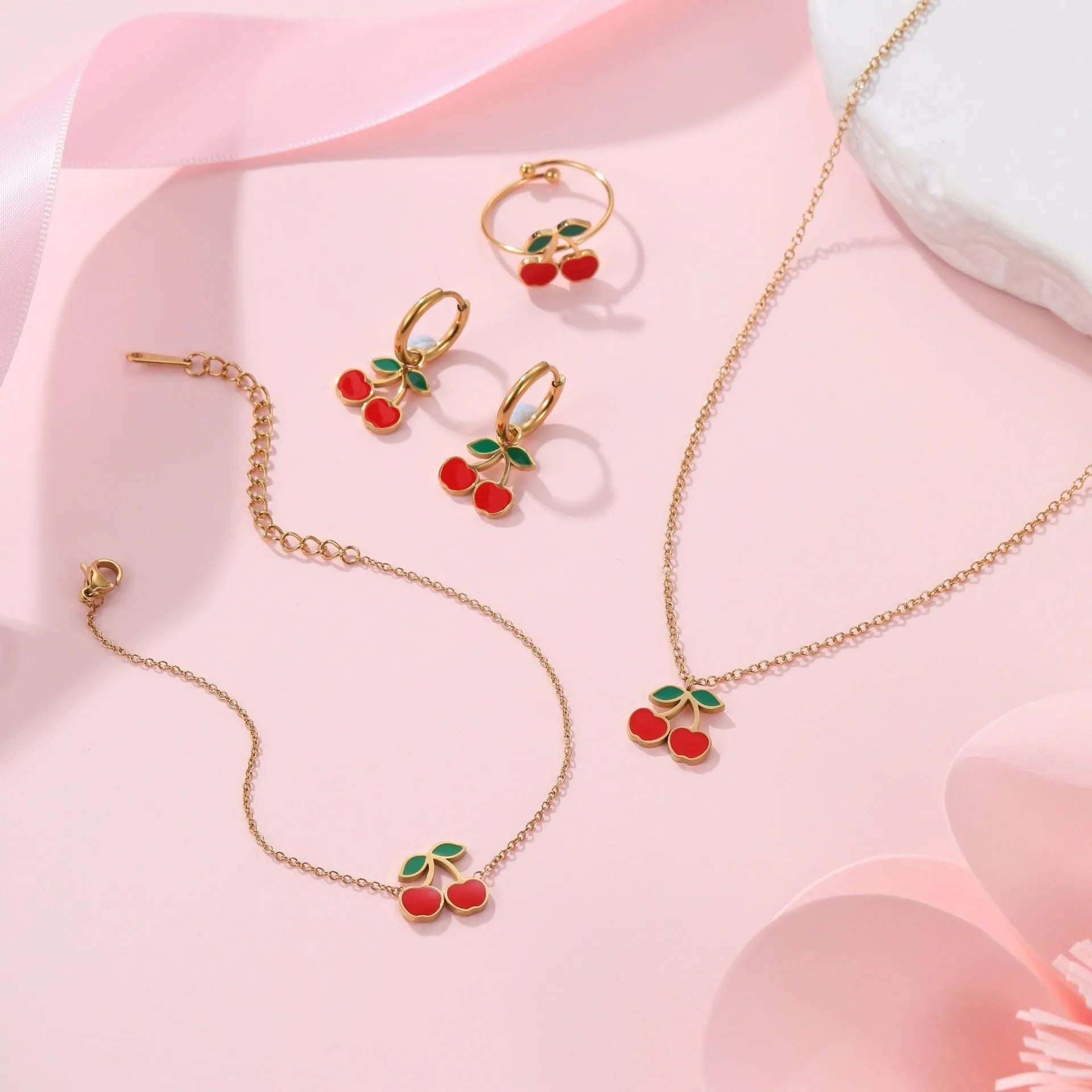 Cherry jewellery set showing necklace, bracelet, earrings, and ring in stainless steel with cherry design