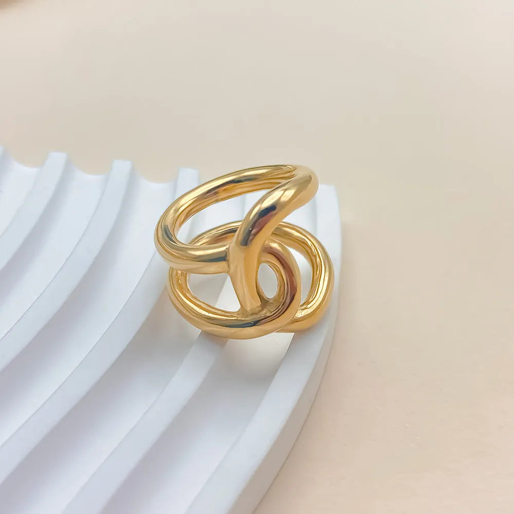 Adjustable open knot ring for women in stainless steel, showing geometric U-shape design in gold or steel colour.