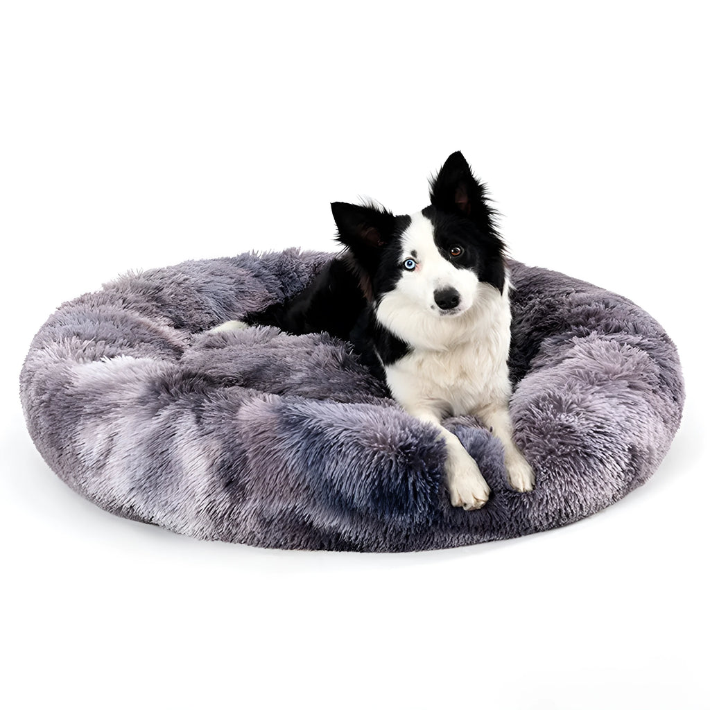 Fluffy donut-shaped dog bed with raised rim in plush fabric, available in multiple colours and four sizes